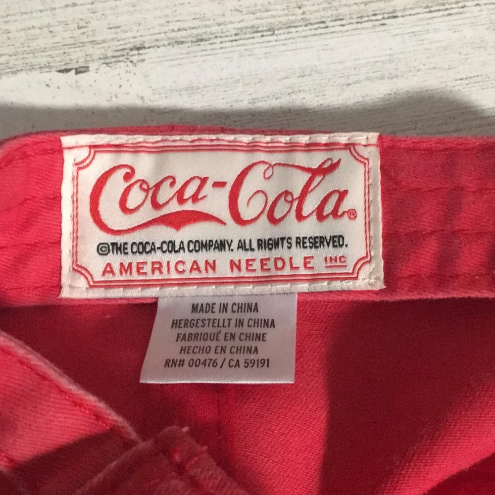 Coca-Cola red adjustable back ball cap with gold tone buckle and white emblem